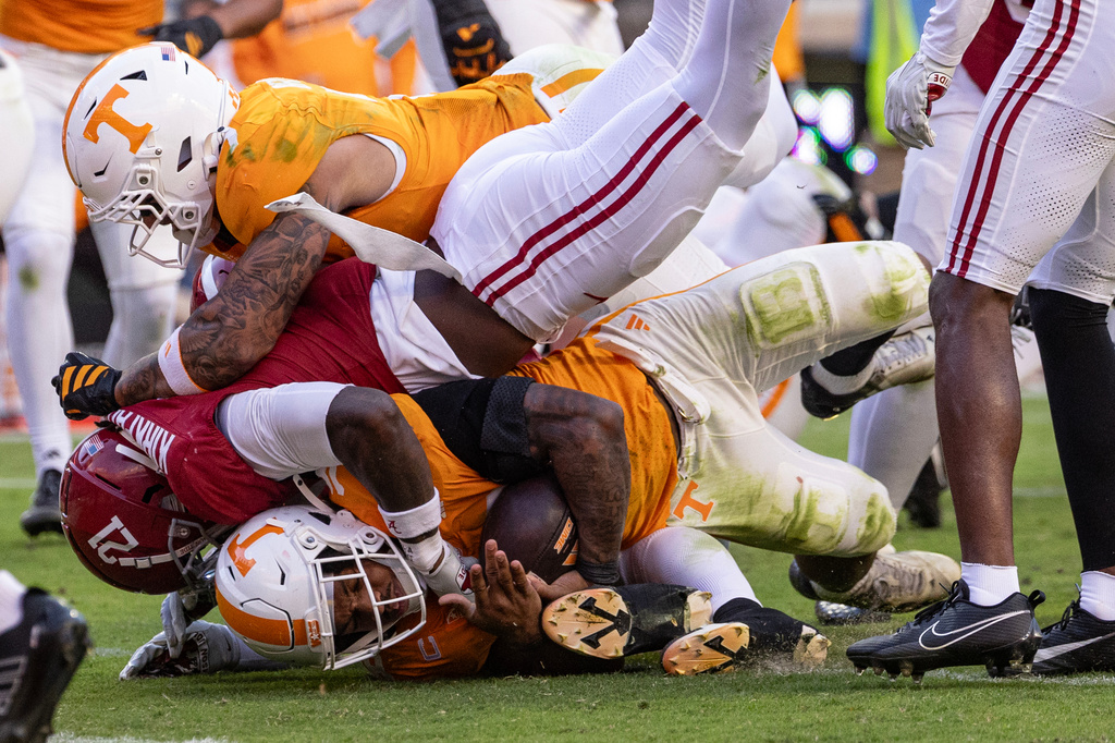 Tennessee running back DeSean Bishop (18) crosses the goal line for a touchdown as he's hit by Alabama defensive back Dre Kirkpatrick Jr. (21) during the second half an NCAA college football game, Saturday, Oct. 17, 2026, in Knoxville, Tenn. (AP Photo/Wade Payne)