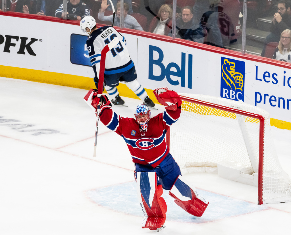 Montreal Canadiens goaltender Jakub Dobes (75) celebrates after making a save against Winnipeg Jets' Gabriel Vilardi (13) during NHL hockey overtime shootout action, in Montreal on Wednesday, Dec. 3, 2025. (Christopher Katsarov/The Canadian Press via AP)