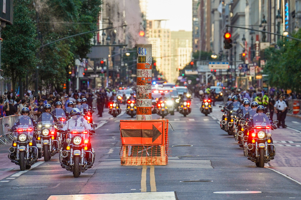NYPD officers escort the motorcade of President Donald Trump outside of Madison Square Garden ahead of Game 3 of the NBA Finals basketball series, Monday, June 8, 2026, in New York. (AP Photo/Ryan Murphy)