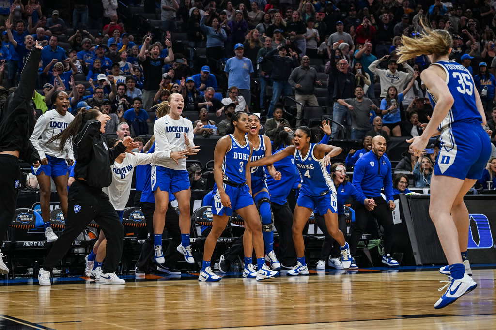FILE - Duke guard Ashlon Jackson (3) is surrounded by cheering teammates after making the game winning three-point basket to defeat LSU in the Sweet 16 of the NCAA college basketball tournament, March 27, 2026, in Sacramento, Calif. (AP Photo/Justine Willard, File)