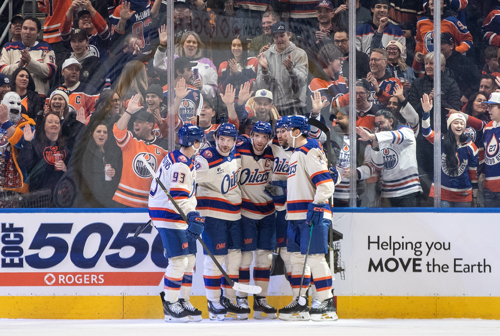 Edmonton Oilers' Ryan Nugent-Hopkins (93), Zach Hyman (18), Connor McDavid (97), Leon Draisaitl (29) and Evan Bouchard (2) celebrate a goal against the Seattle Kraken during first period NHL action, in Edmonton on Thursday, Dec. 4, 2025. (Jason Franson/The Canadian Press via AP)