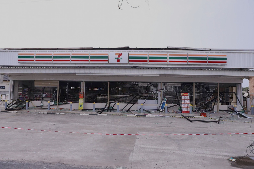 This image provided by The Government's Internal Security Operations Command, shows a 7-Eleven convenience store damaged the night before by arson in Pattani province, Thailand, Sunday, Aug. 23, 2026. (The Government's Internal Security Operations Command Via AP)