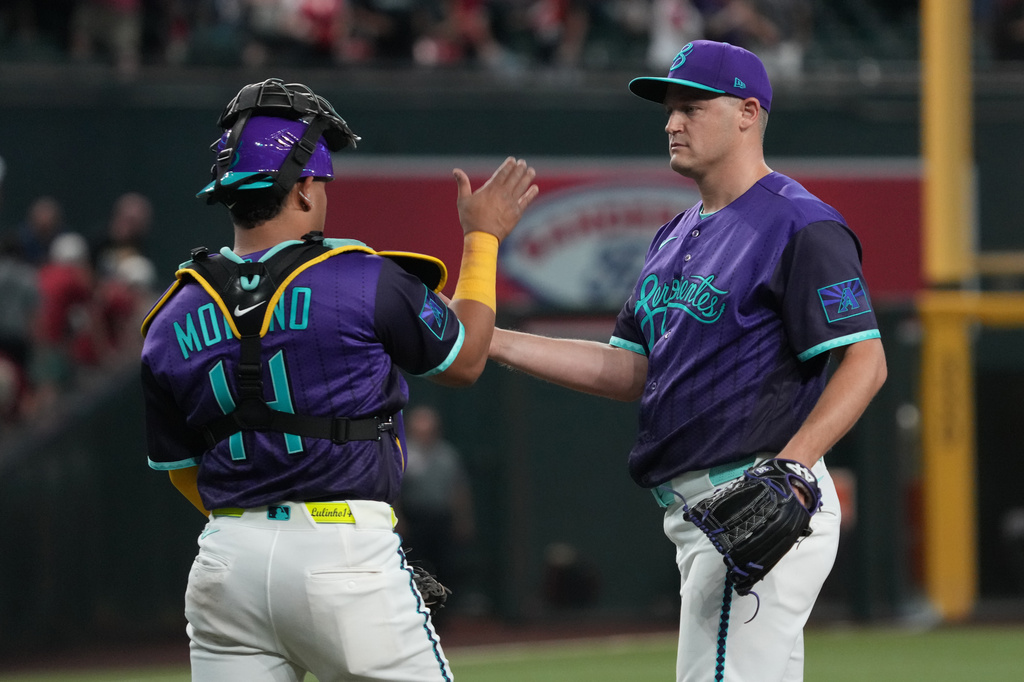 Arizona Diamondbacks catcher Gabriel Moreno (14) and pitcher Paul Sewald celebrate after defeating the Minnesota Twins during a baseball game, Friday, June 19, 2026, in Phoenix. (AP Photo/Rick Scuteri)