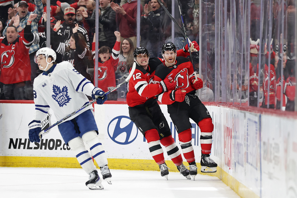 New Jersey Devils right wing Connor Brown, right, is congratulated by New Jersey Devils center Cody Glass (12) after scoring a goal during the third period of an NHL hockey game against the Toronto Maple Leafs, Wednesday, March 4, 2026, in Newark, N.J. (AP Photo/Adam Hunger)