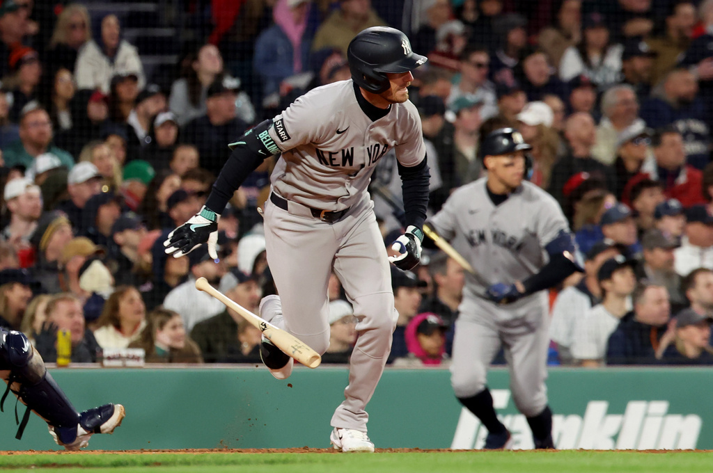 New York Yankees' Cody Bellinger runs to first base on a two RBI single during the seventh inning of a baseball game against the Boston Red Sox, Thursday, April 23, 2026, in Boston. (AP Photo/Mark Stockwell)