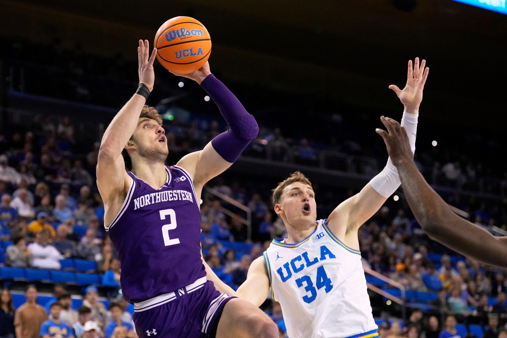 Northwestern forward Nick Martinelli, left, shoots as UCLA forward Tyler Bilodeau defends during the first half of an NCAA college basketball game, Saturday, Jan. 24, 2026, in Los Angeles. (AP Photo/Mark J. Terrill)