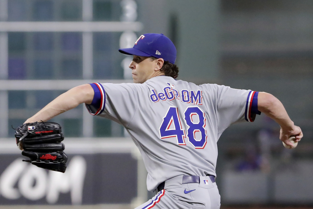 Texas Rangers starting pitcher Jacob deGrom throws against the Houston Astros during the first inning of a baseball game Wednesday, Sept. 17, 2025, in Houston. (AP Photo/Michael Wyke)