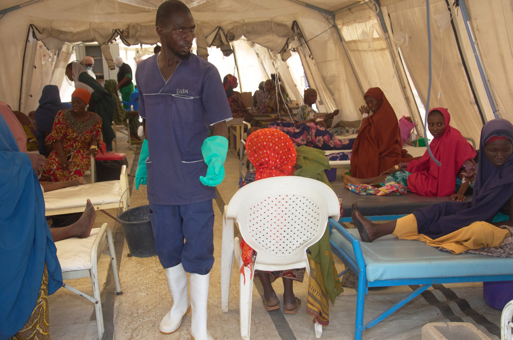 A worker walks past patients receiving cholera treatment at the MSF treatment centre in Maiduguri, Nigeria, Monday, June 8, 2026. (AP Photo/Jude Mike)