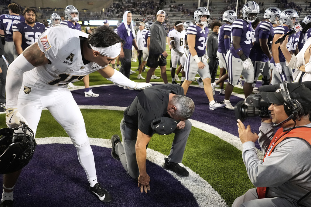Army head coach Jeff Monken is congratulated by wide receiver Noah Short (15) after beating Kansas State in an NCAA college football game Saturday, Sept. 6, 2025, in Manhattan, Kan. (AP Photo/Charlie Riedel)