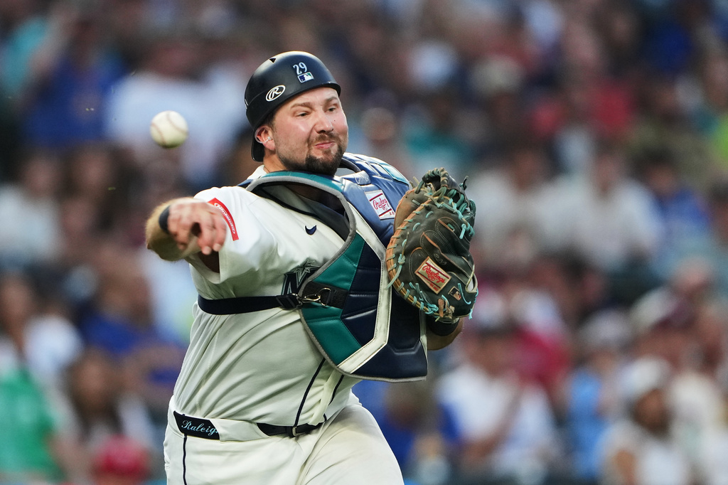Seattle Mariners catcher Cal Raleigh throws to first for the out against Philadelphia Phillies' Trea Turner during the fifth inning of a baseball game, Tuesday, Aug. 25, 2026, in Seattle. (AP Photo/Lindsey Wasson)