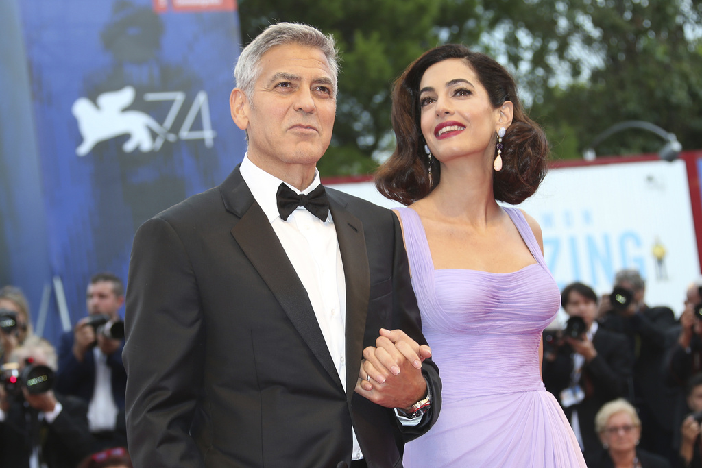 FILE - George Clooney, left, and Amal Clooney appear at the premiere of the film "Suburbicon" during the 74th edition of the Venice Film Festival in Venice, Italy on Sept. 2, 2017. (Photo by Joel Ryan/Invision/AP, File)