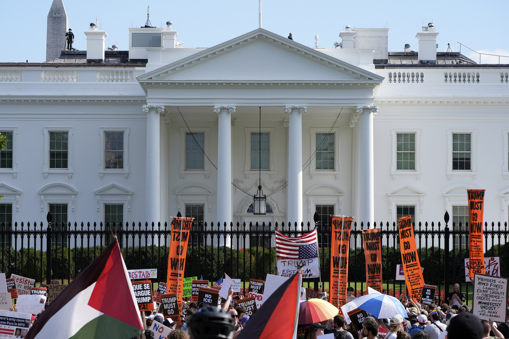 Activists protest President Donald Trump's federal takeover of policing of the District of Columbia near the White House, Saturday, Aug. 16, 2025, in Washington. (AP Photo/Alex Brandon)