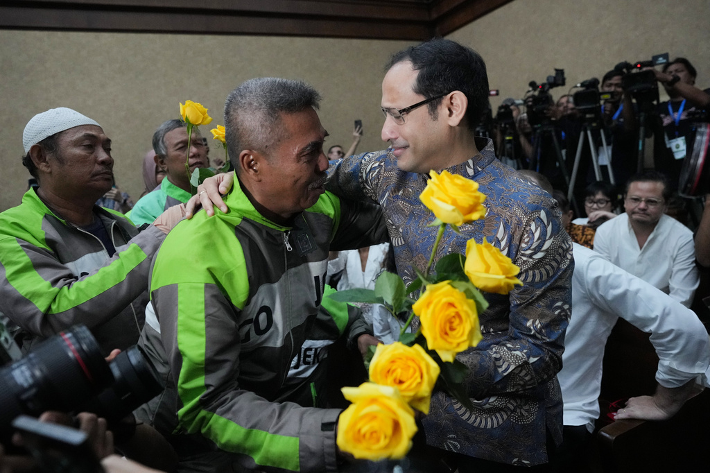 Fomer Education Minister Nadiem Anwar Makarim, also the co-founder of ride-hailing and payment giant Gojek, is greeted by supporters before his sentencing hearing in a Google Chromebook laptop procurement corruption case, at the Corruption Court in Jakarta, Indonesia, Tuesday, June 30, 2026. (AP Photo/Tatan Syuflana)