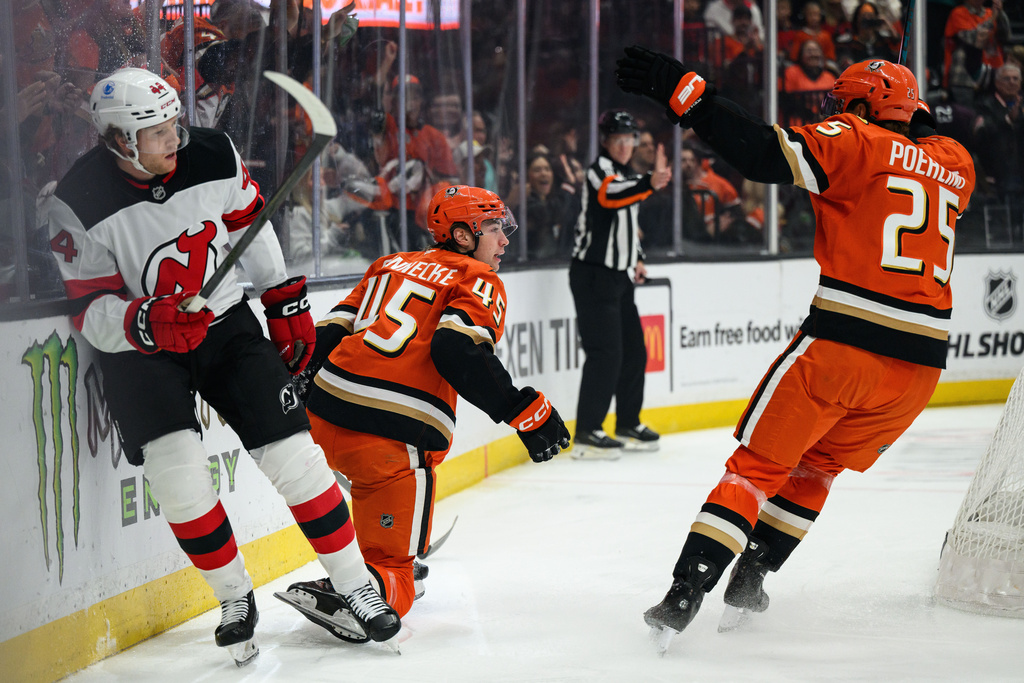 Anaheim Ducks right wing Beckett Sennecke (45) is greeted by center Ryan Poehling (25) after scoring during the first period of an NHL hockey game against the New Jersey Devils, Sunday, Nov. 2, 2025, in Anaheim, Calif. (AP Photo/William Liang)