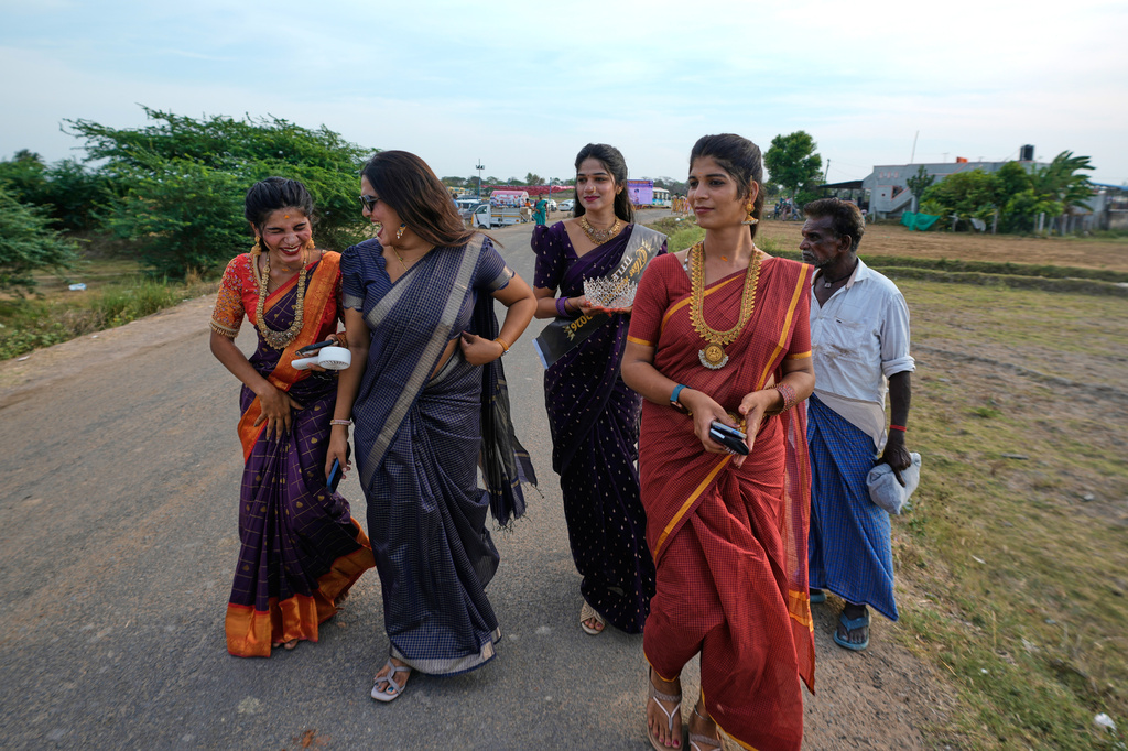 Nazariya Kutty, second right, with her friends arrive to participate in the Koovagam transgender festival in Kallakurichi district, in the southern Indian state of Tamil Nadu, Tuesday, April 28, 2026. (AP Photo/Mahesh Kumar A.)