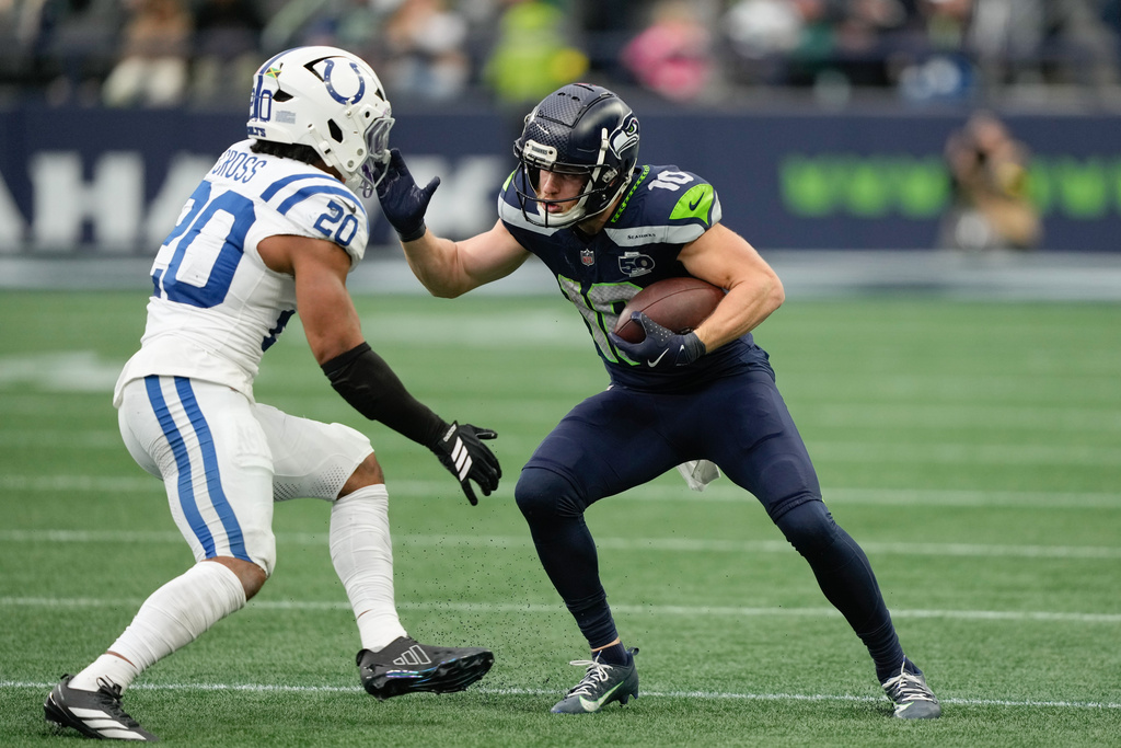 Seattle Seahawks wide receiver Cooper Kupp (10) runs with the ball as Indianapolis Colts safety Nick Cross (20) defends during the second half of an NFL football game Sunday, Dec. 14, 2025, in Seattle. (AP Photo/Stephen Brashear)