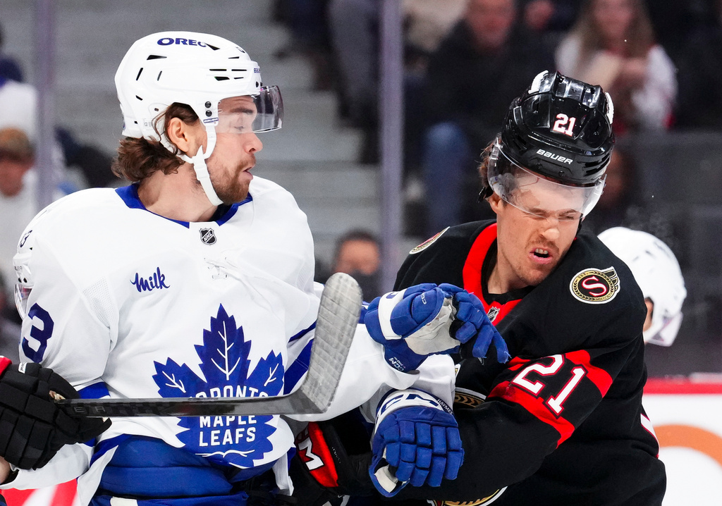 Toronto Maple Leafs' Matias MacCelli (63) collides with Ottawa Senators' Nick Cousins (21) during the first period of an NHL hockey game in Ottawa, Ontario, on Wednesday, April 15, 2026. (Sean Kilpatrick/The Canadian Press via AP)