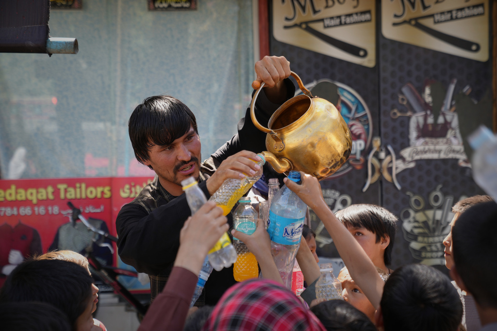 Afghan Shiite worshippers receive juice from a stand before attending Muharram religious ceremonies ahead of Ashoura at the Chendawol Mosque in Kabul, Afghanistan, Thursday, June 25, 2026. (AP Photo/Siddiqullah Alizai)