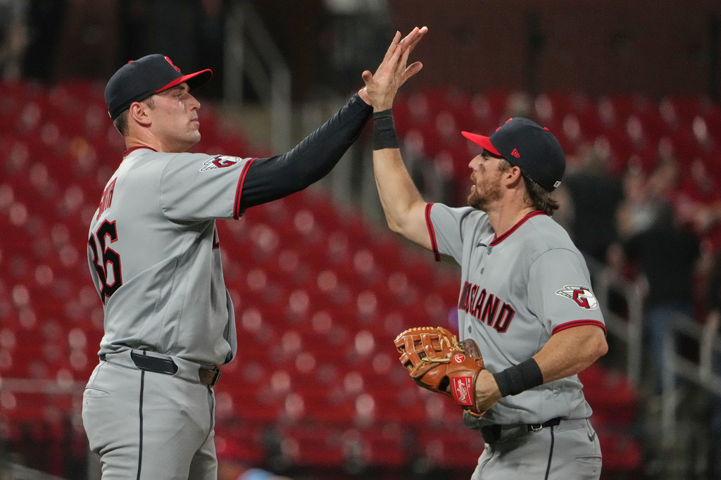 Cleveland Guardians pitcher Cade Smith and Daniel Schneemann celebrate a victory over the St. Louis Cardinals following a baseball game Monday, April 13, 2026, in St. Louis. (AP Photo/Jeff Roberson)