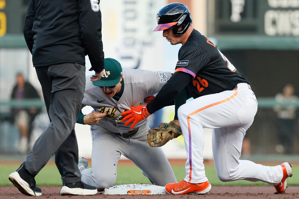 San Francisco Giants third baseman Matt Chapman (26) on his way to second base steps on the right hand of Athletics of infielder Zack Gelof (20) in the 2nd inning of a baseball game in San Francisco, Tuesday, June 23, 2026. (Santiago Mejia/San Francisco Chronicle via AP)