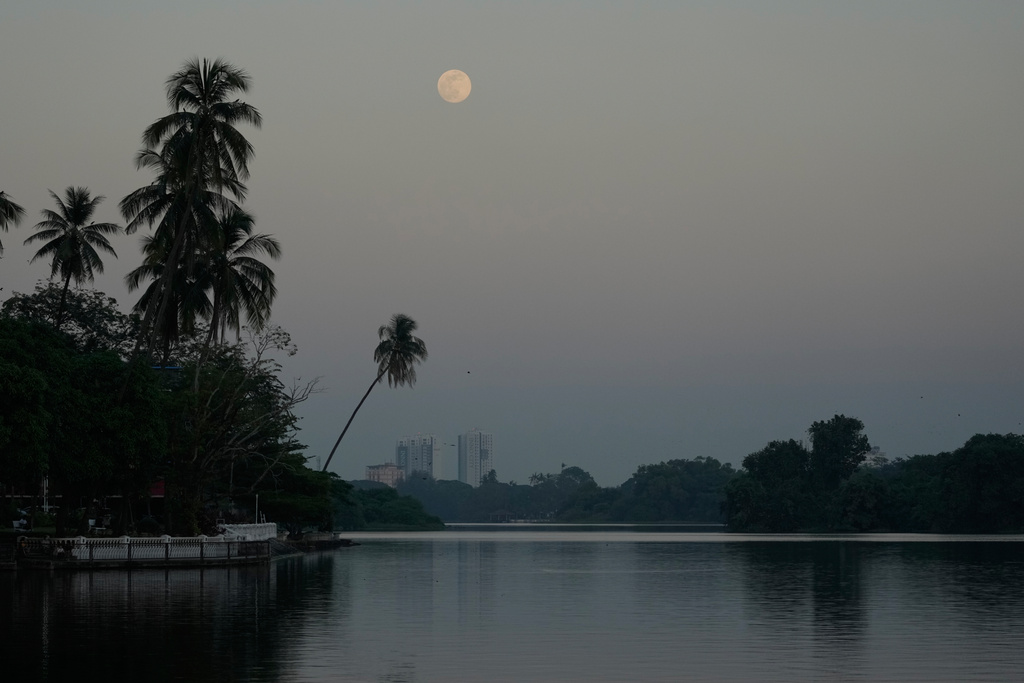The moon rising near Inya Lake is seen Thursday, Dec.4, 2025, in Yangon, Myanmar. (AP Photo/Thein Zaw)