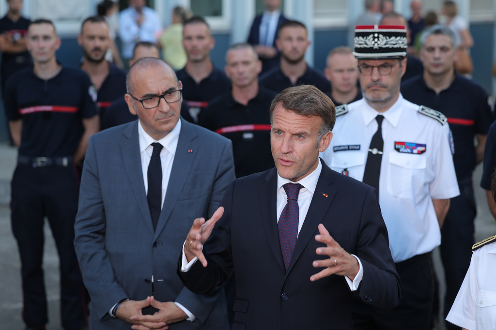 France's President Emmanuel Macron, center, speaks to the press next to Interior Minister Laurent Nunez, left, after a visit to the departmental fire and rescue operational center (CODIS) in Bordeaux, France, following wildfires in the area, Monday July 27, 2026. (Kenzo Tribouillard/Pool Photo via AP)