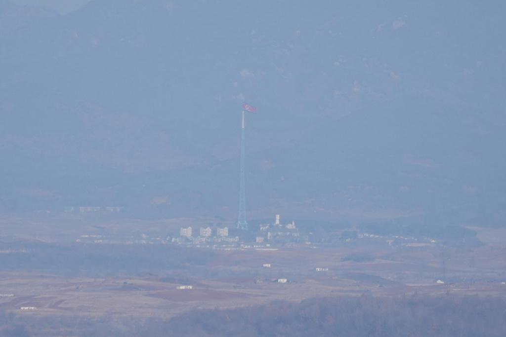 A North Korean flag flutters in the wind atop a 160-meter (525-foot) tower in the North's Kijong-dong village near the truce village of Panmunjom, seen from Paju, South Korea, near the border with North Korea, on Dec. 25, 2025. (AP Photo/Lee Jin-man)