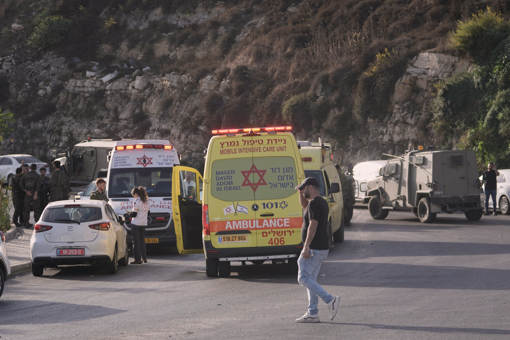 Israeli soldiers and emergency personnel gather near ambulances following a shooting attack near Yehuda Junction, near Hebron, in the occupied West Bank, Friday, Oct. 23, 2026. (AP Photo/Mahmoud Illean)