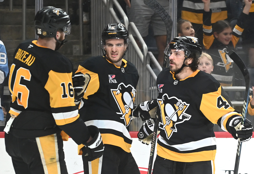Pittsburgh Penguins defenseman Ryan Shea (5) celebratesa goal with right wing Justin Brazeau (16) and defenseman Samuel Girard (49) against the Florida Panthers during the second period of an NHL game, Saturday, April 4, 2026, in Pittsburgh. (AP Photo/Philip G. Pavely)