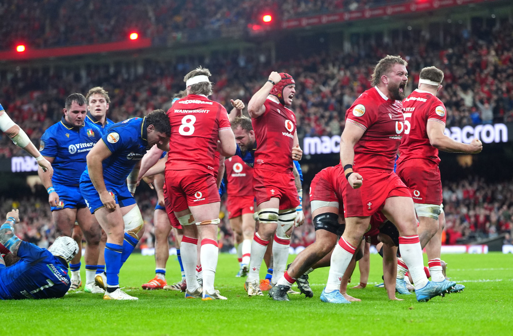 Wales players celebrate their side's third try of the game, scored by Dewi Lake, during the Men's Six Nations match between Wales and Italy in Cardiff, Wales, Saturday March 14, 2026. (David Davies/PA via AP)