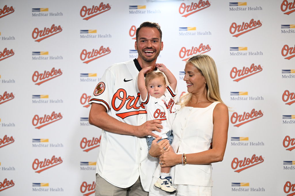 Former Baltimore Oriole Trey Mancini poses with his wife Sara Perlman and daughter Sadie after announcing his retirement as an Oriole during a news conference on Saturday, Sept. 19, 2026 in Baltimore. (AP Photo/Gail Burton)
