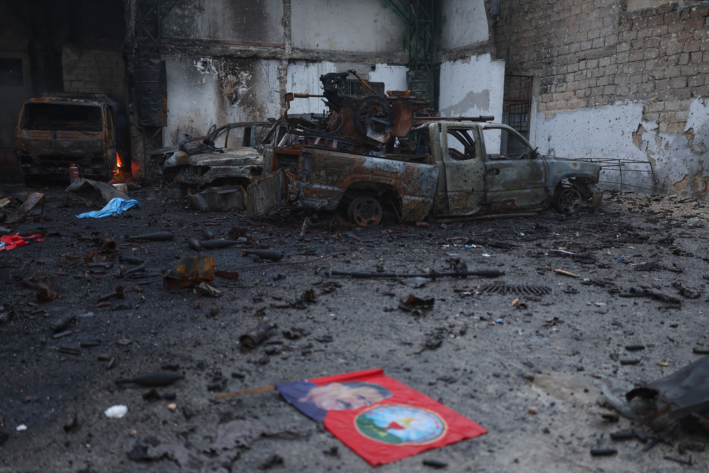 Burned vehicles at one of the Kurdish fighters positions at the Sheikh Maqsoud neighborhood, where clashes between government forces and Kurdish fighters have been taking place in the northern city of Aleppo, Syria, Sunday, Jan. 11, 2026. (AP Photo/Ghaith Alsayed)