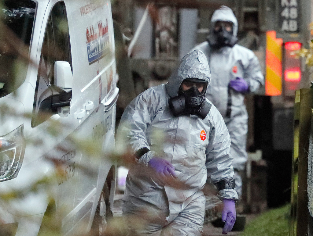 FILE - In this March 12, 2018, photo, personnel in protective gear work on a van in Winterslow, England, as investigations continue into the nerve-agent poisoning of Russian ex-spy Sergei Skripal and his daughter Yulia, in Salisbury, England. (AP Photo/Frank Augstein, File)