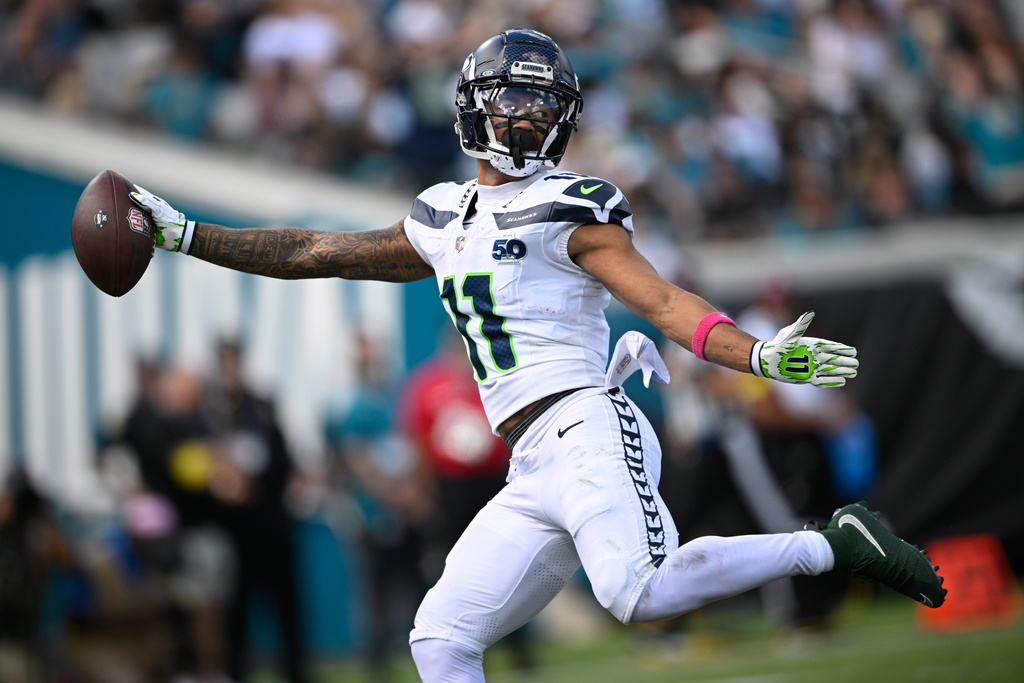 Seattle Seahawks wide receiver Jaxon Smith-Njigba (11) catches a touchdown pass on a 61-yard pass play during the first half of an NFL football game against the Jacksonville Jaguars, Sunday, Oct. 12 2025, in Jacksonville, Fla. (AP Photo/Phelan M. Ebenhack)