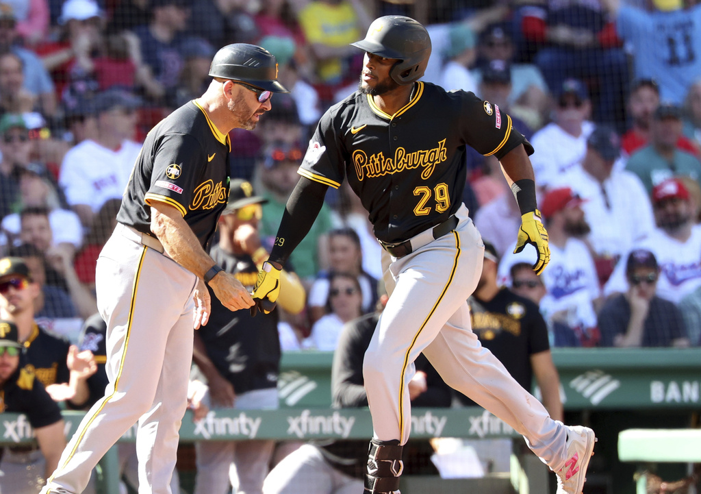 Pittsburgh Pirates' Alexander Canario (29) high fives third base coach Mike Rabelo after hitting a home run during the seventh inning of a baseball game against the Boston Red Sox, Sunday, Aug. 31, 2025, in Boston. (AP Photo/Mark Stockwell)