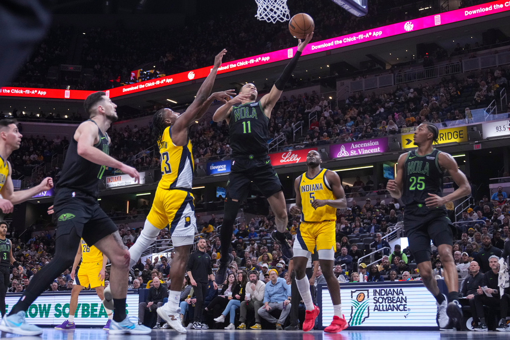 New Orleans Pelicans guard Bryce McGowens (11) shoots over Indiana Pacers guard Aaron Nesmith (23) during the first half of an NBA basketball game in Indianapolis, Friday, Jan. 16, 2026. (AP Photo/Michael Conroy)