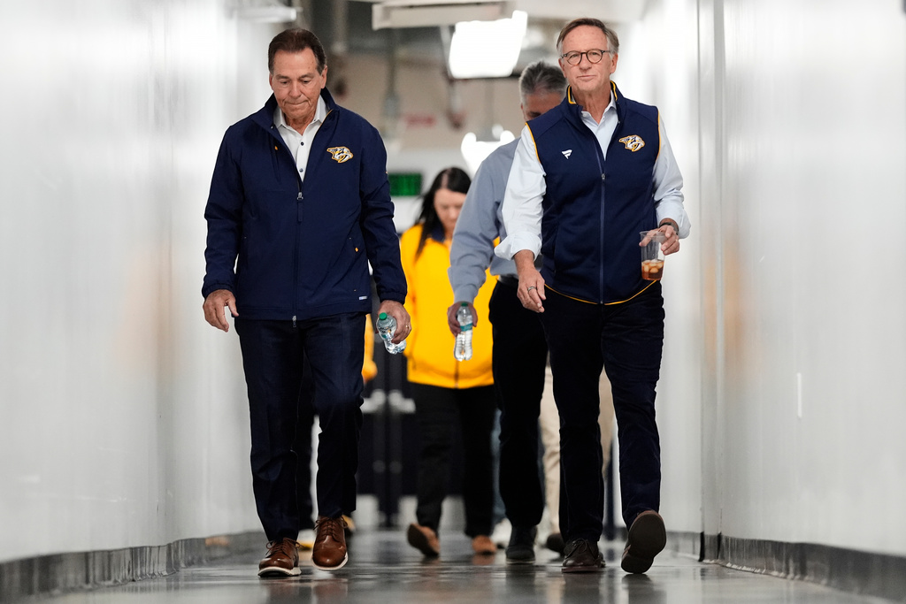 Nick Saban, left, and Nashville Predators majority owner Bill Haslam arrive for a news conference announcing Saban's minority ownership of the NHL hockey team Monday, Dec. 22, 2025, in Nashville, Tenn. (AP Photo/George Walker IV)