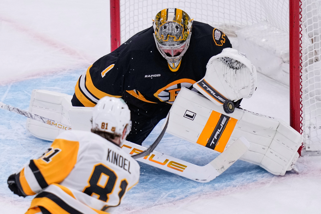 Boston Bruins goaltender Jeremy Swayman (1) makes a save on a shot by Pittsburgh Penguins center Ben Kindel (81) during the second period of an NHL hockey game, Tuesday, March 3, 2026, in Boston. (AP Photo/Charles Krupa)
