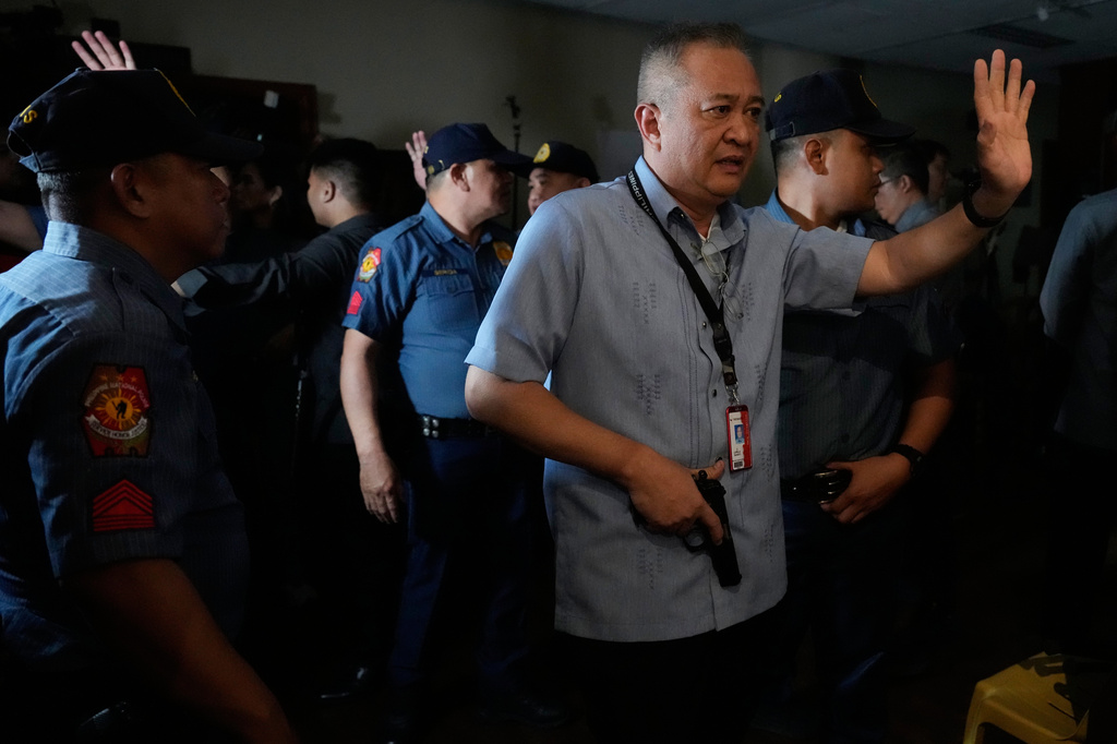 Senate security clear the area of media as gunshots were fired at the Philippine Senate in Pasay, Philippines on Wednesday, May 13, 2026. (AP Photo/Aaron Favila)