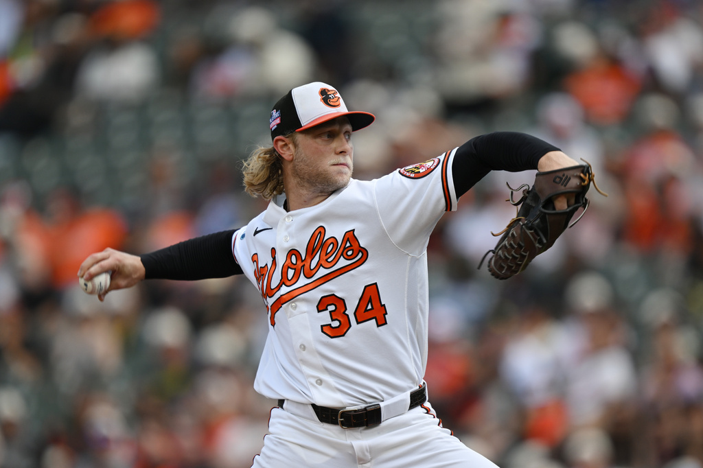 Baltimore Orioles pitcher Shane Baz delivers against the Tampa Bay Rays in the first inning of a baseball game Sunday, Aug. 23, 2026, in Baltimore. (AP Photo/Gail Burton)