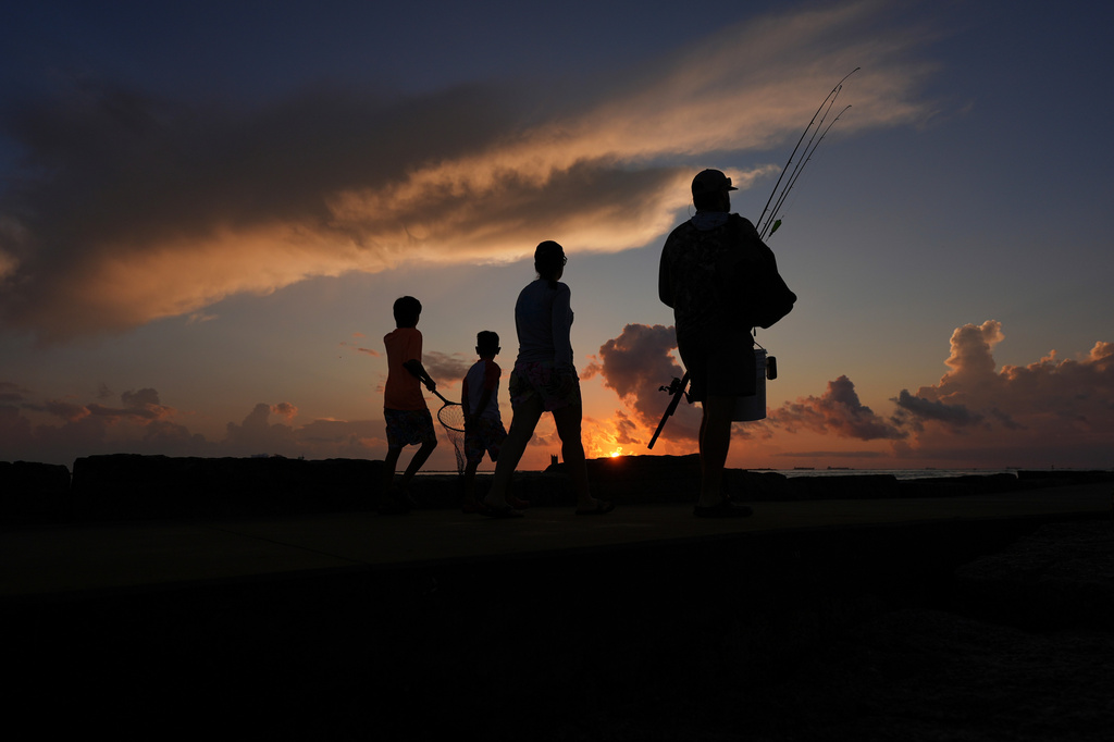 FILE - A family prepares to fish along a jetty at sunrise in Port Aransas, Texas, on Aug. 10, 2025. (AP Photo/Eric Gay, File)