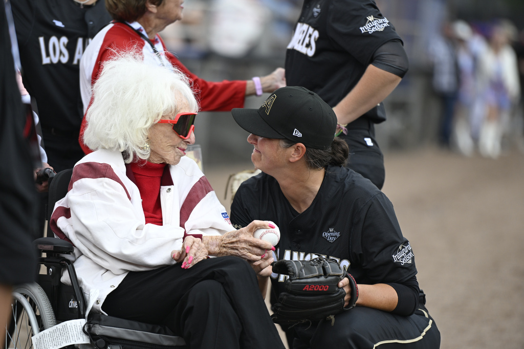 Former All-American Girls Professional Baseball League player Maybelle Blair, left, and Los Angeles Queens' Meggie Meidlinger, right, share a moment before the inaugural Women's Professional Baseball League game against the New York Heights, Saturday, Aug. 1, 2026, in Springfield, Ill. (AP Photo/Lexie Knight) CORRECTION: Corrects to Queens' Meggie Meidlinger not Elodie O'Sullivan.