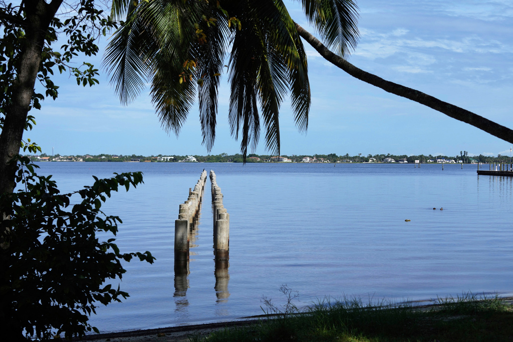 The remains of the Edison pier are shown along the Caloosahatchee River in front of the Edison and Ford Winter Estates, Saturday, Aug. 9, 2025, in Fort Myers, Fla. (AP Photo/Lynne Sladky)
