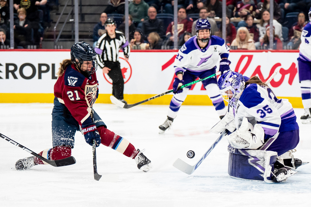 Minnesota Frost goaltender Maddie Rooney (35) makes a save on Montreal Victoire's Maureen Murphy (21) during the second period of a PWHL hockey playoff game in Laval, Quebec, on Tuesday, May 12, 2026. (Christopher Katsarov/The Canadian Press via AP)