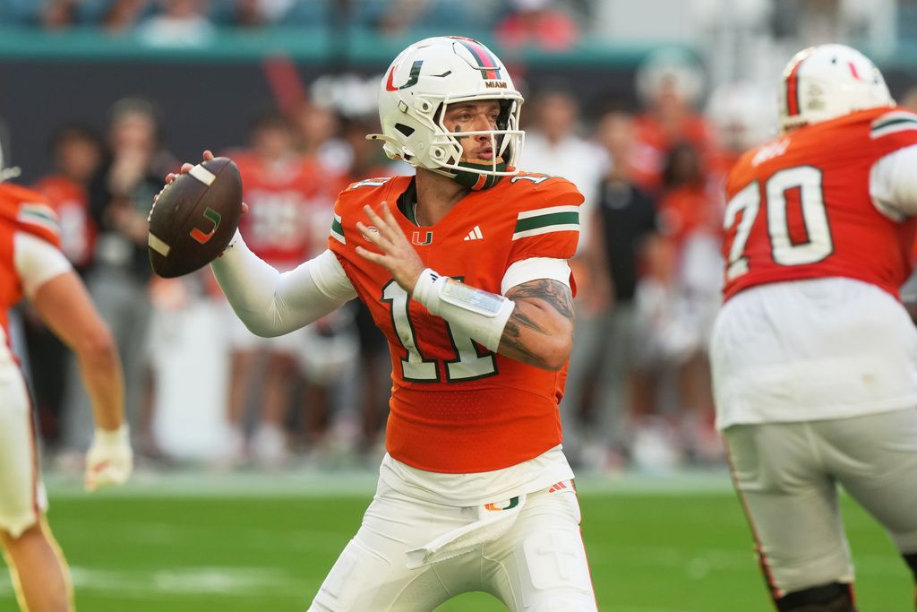 Miami quarterback Carson Beck (11) aims a pass during the first half of an NCAA college football game against Syracuse Saturday, Nov. 8, 2025, in Miami Gardens, Fla. (AP Photo/Marta Lavandier)