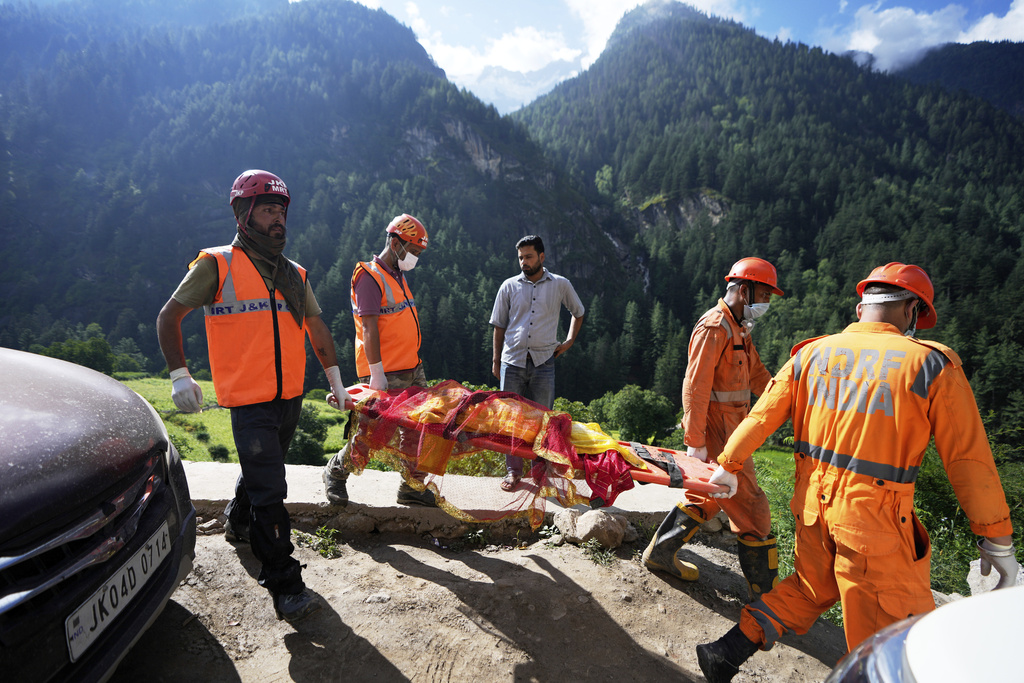 FILE - India's National Disaster Response Force (NDRF) personnel carry a dead body on a stretcher during rescue operations after Thursday's flash floods in Chositi village, Kishtwar district, Indian-controlled Kashmir, Aug. 16, 2025. (AP Photo/Channi Anand, File)