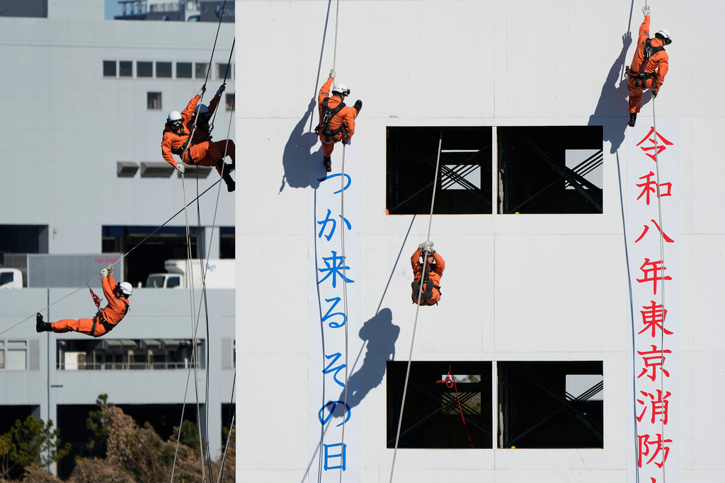 Members of the rescue team perform during the annual New Year's Fire Brigade Review Tuesday, Jan. 6, 2026, in Tokyo. (AP Photo/Eugene Hoshiko)
