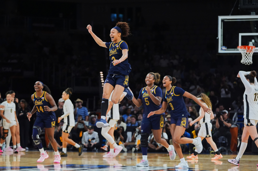 Notre Dame guard Hannah Hidalgo, top, and teammates celebrate the teams win against Vanderbilt in the Sweet 16 of the NCAA college basketball tournament, Friday, March 27, 2026, in Fort Worth, Texas. (AP Photo/LM Otero)