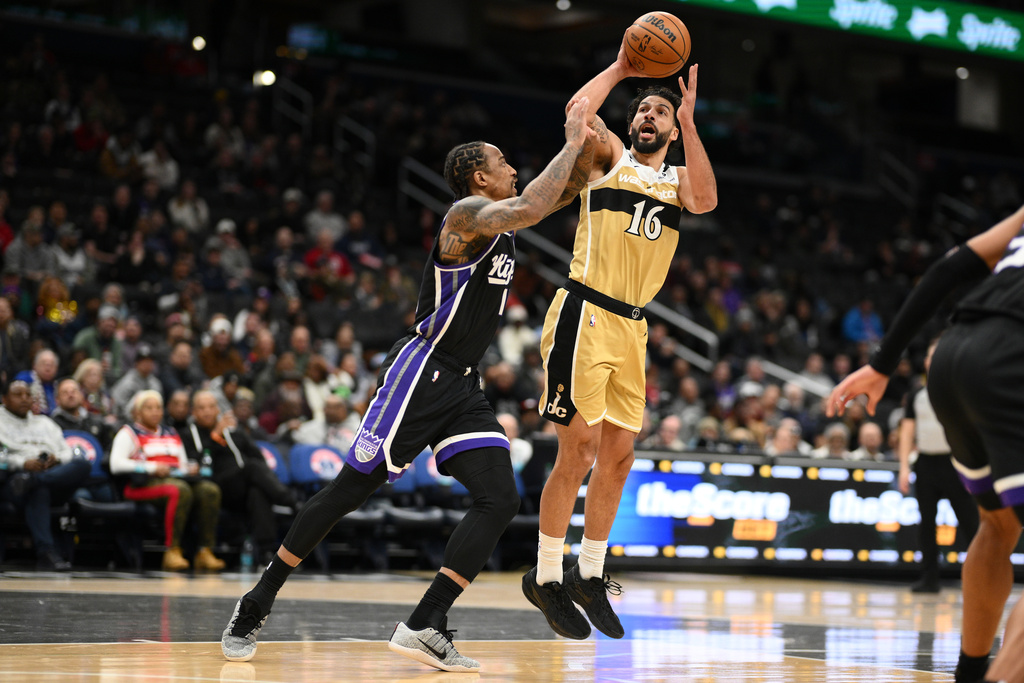 Washington Wizards forward Anthony Gill (16) shoots against Sacramento Kings guard DeMar DeRozan, left, during the first half of an NBA basketball game, Sunday, Feb. 1, 2026, in Washington. (AP Photo/Nick Wass)