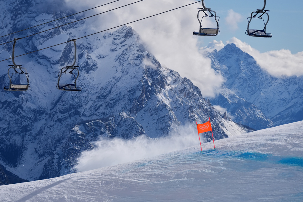 A cloud of snow is created by the crash of United States' Lindsey Vonn during an alpine ski women's downhill race, at the 2026 Winter Olympics, in Cortina d'Ampezzo, Italy, Sunday, Feb. 8, 2026. (AP Photo/Jacquelyn Martin)